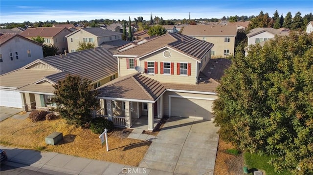 view of front of home featuring covered porch and a garage