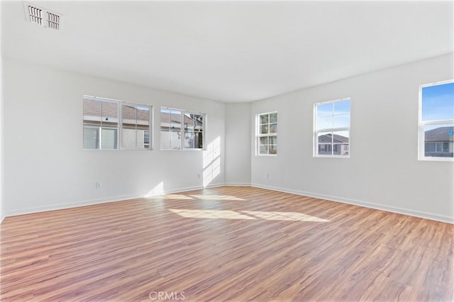 empty room with basketball court and light wood-type flooring