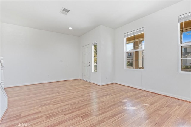 unfurnished room with light hardwood / wood-style flooring