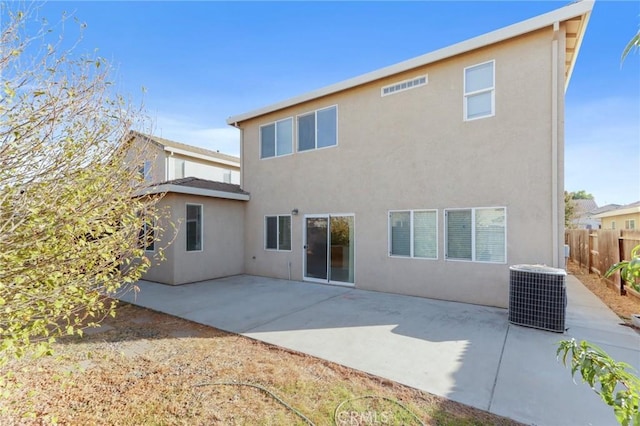 rear view of property with a patio and central AC