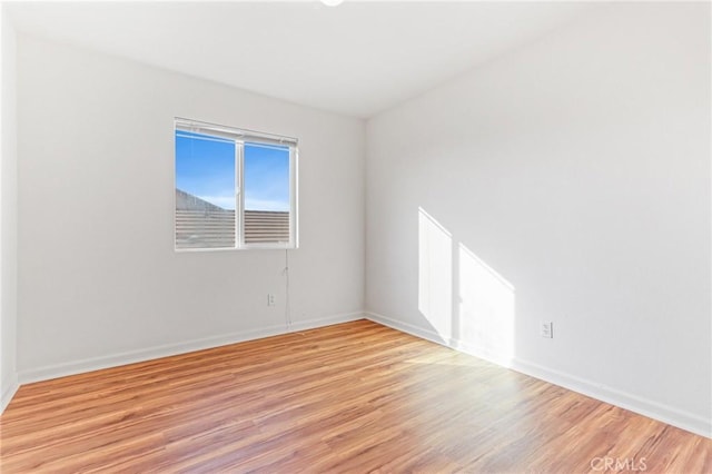 spare room featuring light hardwood / wood-style floors