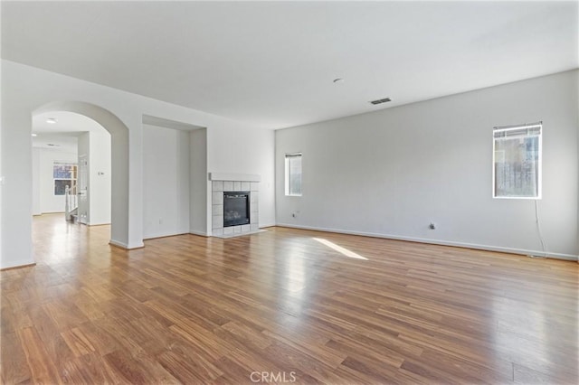 unfurnished living room with light wood-type flooring and a healthy amount of sunlight