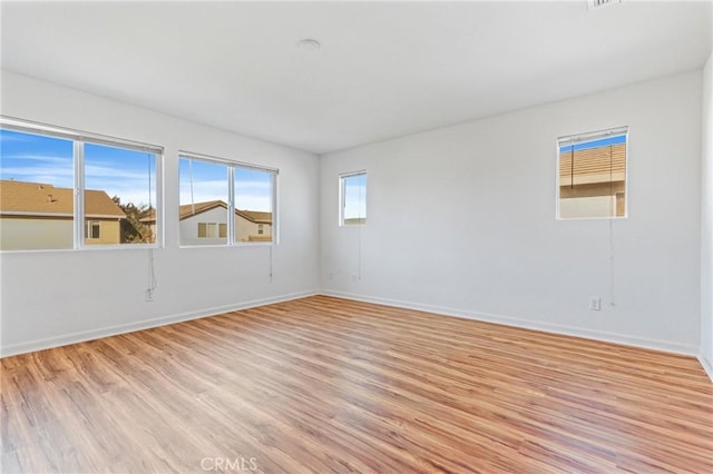 empty room with light hardwood / wood-style floors