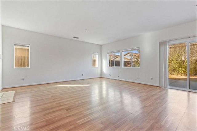 spare room featuring light hardwood / wood-style floors