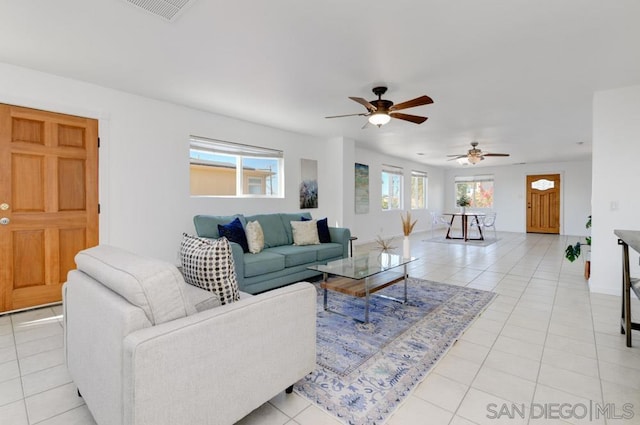 tiled living room featuring ceiling fan