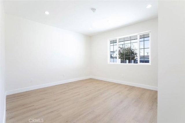 spare room featuring light hardwood / wood-style flooring