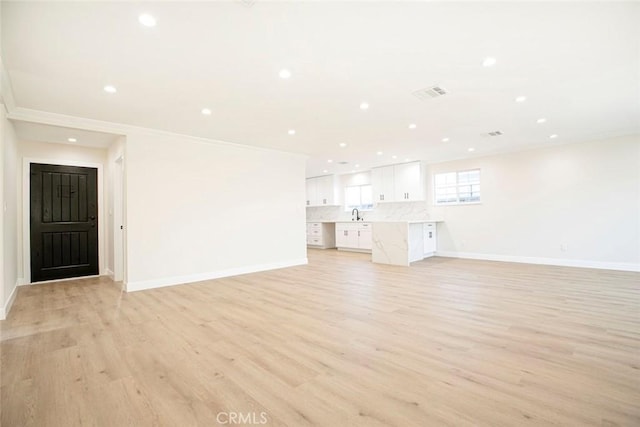 unfurnished living room with light wood-type flooring