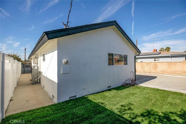 view of home's exterior with a lawn and a patio area