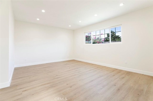 spare room featuring light hardwood / wood-style flooring