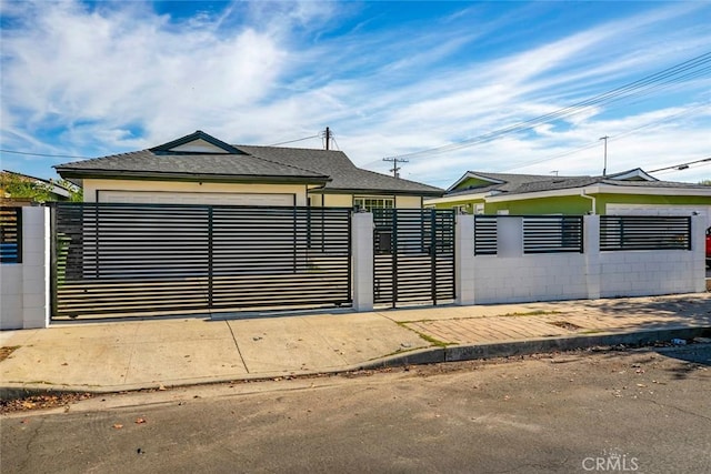 view of gate with a garage