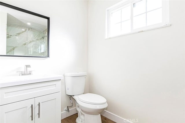 bathroom with vanity, toilet, an enclosed shower, and hardwood / wood-style floors