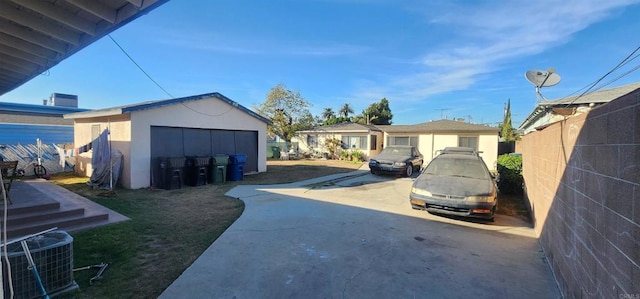 view of yard with central AC unit, an outdoor structure, and a garage