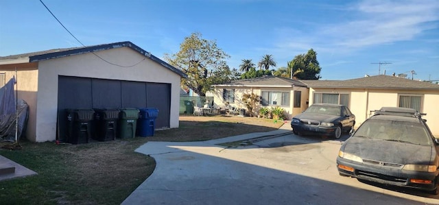 view of front of home with a garage and an outdoor structure