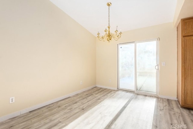 unfurnished room featuring a chandelier, lofted ceiling, and light hardwood / wood-style flooring