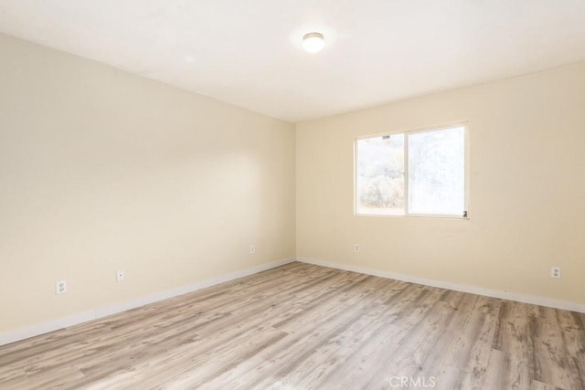 spare room featuring light hardwood / wood-style floors