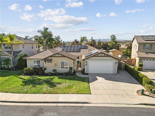 view of front of property featuring solar panels, a garage, and a front lawn