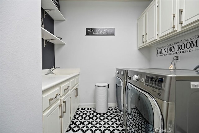 clothes washing area featuring washer and dryer, cabinets, and sink