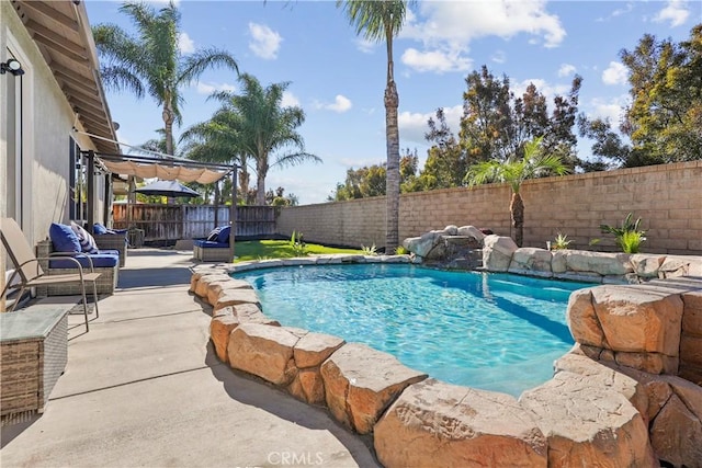 view of swimming pool with pool water feature and a patio