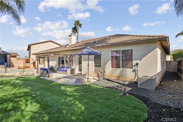 rear view of property featuring a lawn, a patio area, an outdoor hangout area, and central AC unit