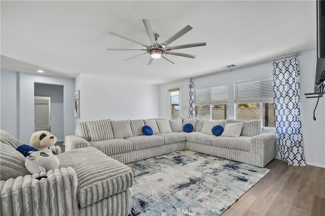 living room with hardwood / wood-style flooring and ceiling fan