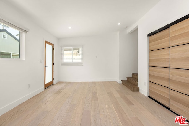 unfurnished room with light wood-type flooring