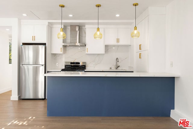 kitchen with white cabinets, sink, wall chimney exhaust hood, and stainless steel appliances