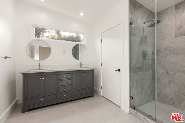 bathroom featuring vanity and a shower with door