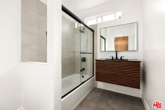 bathroom with vanity and bath / shower combo with glass door