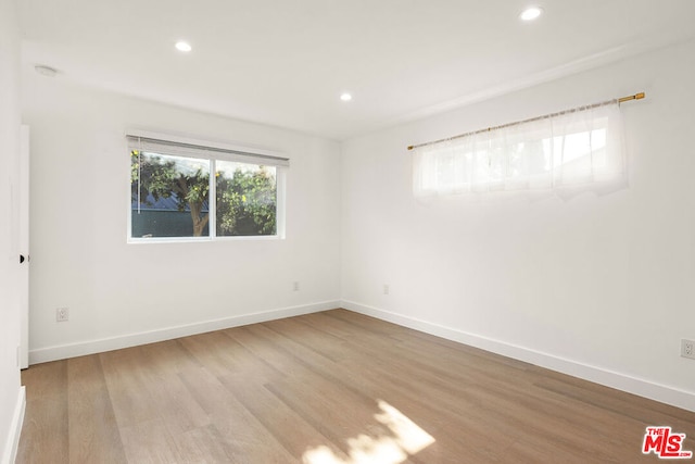 unfurnished room featuring light wood-type flooring