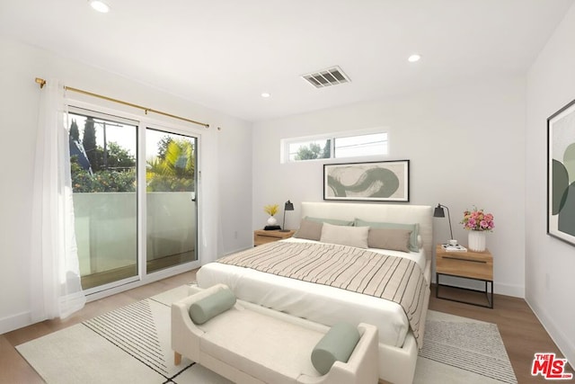 bedroom featuring access to exterior and light hardwood / wood-style floors