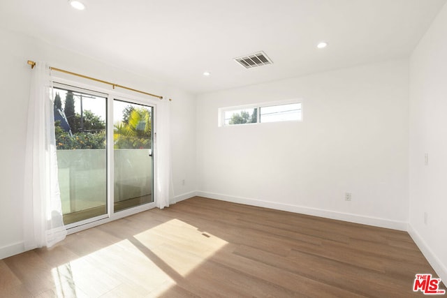 unfurnished room featuring hardwood / wood-style flooring