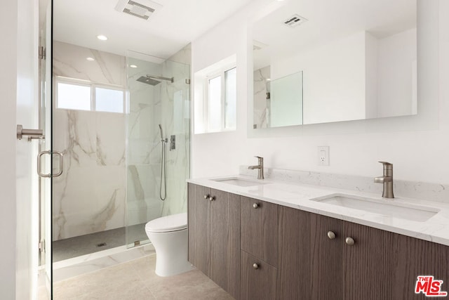 bathroom featuring tile patterned floors, vanity, toilet, and plenty of natural light