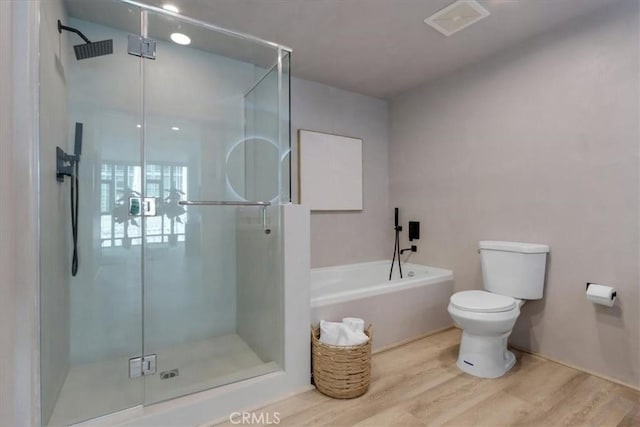 bathroom featuring separate shower and tub, toilet, and wood-type flooring