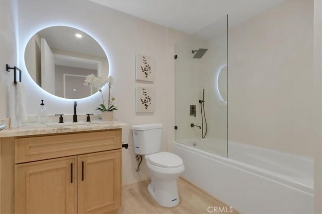 full bathroom with shower / bath combination with glass door, vanity, and toilet