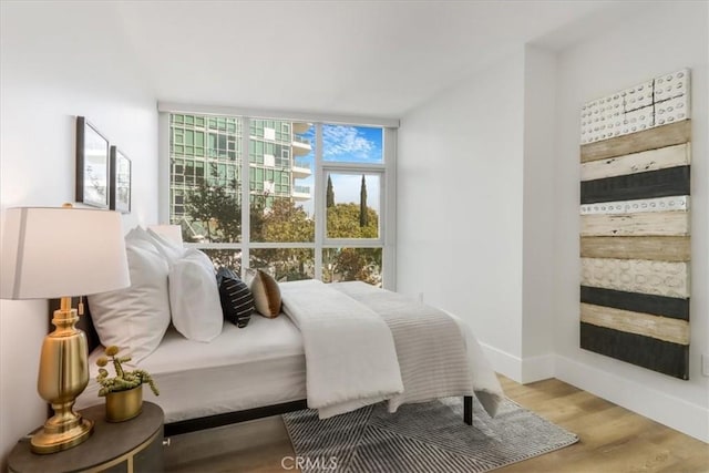 bedroom with hardwood / wood-style floors