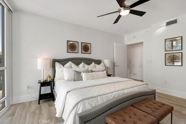 bedroom with ceiling fan and light hardwood / wood-style floors