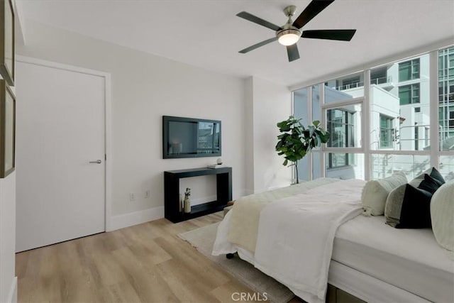 bedroom with ceiling fan and light wood-type flooring