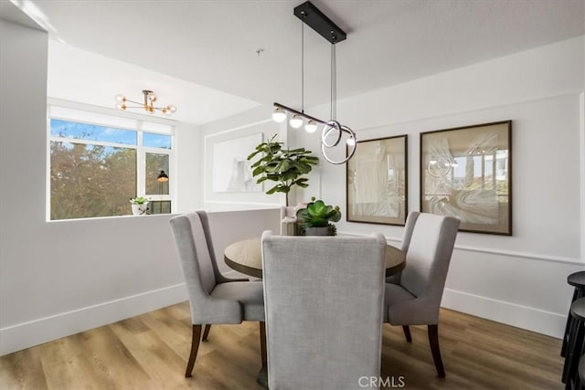 dining space featuring a chandelier and hardwood / wood-style flooring