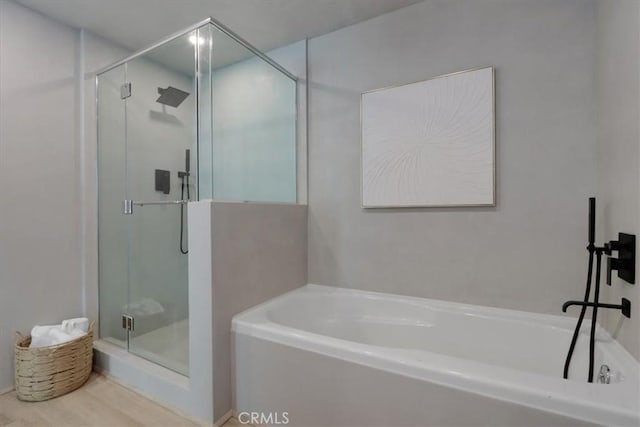 bathroom featuring shower with separate bathtub