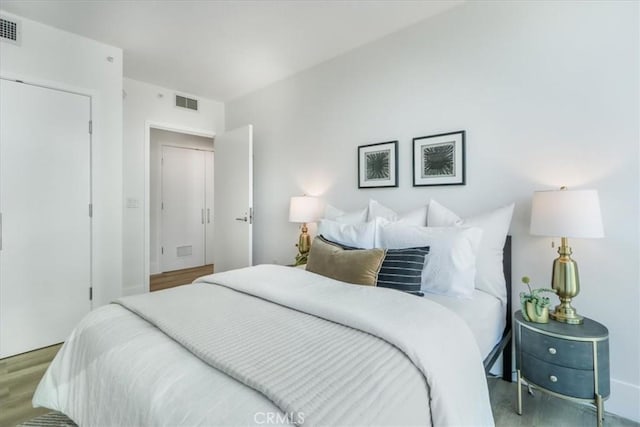 bedroom with wood-type flooring