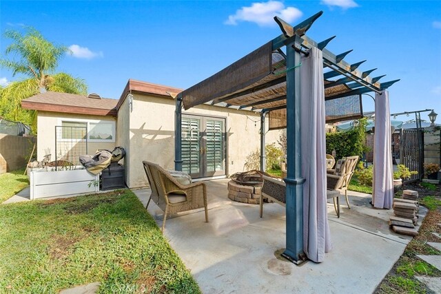 view of patio / terrace featuring a pergola and a fire pit