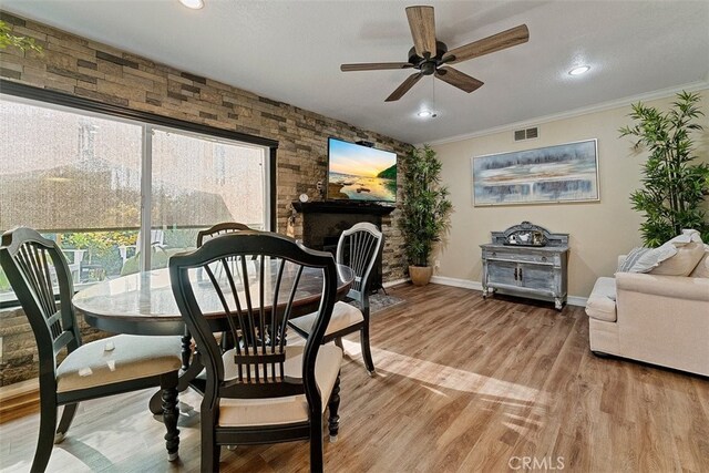 dining area with ceiling fan, crown molding, and light hardwood / wood-style floors