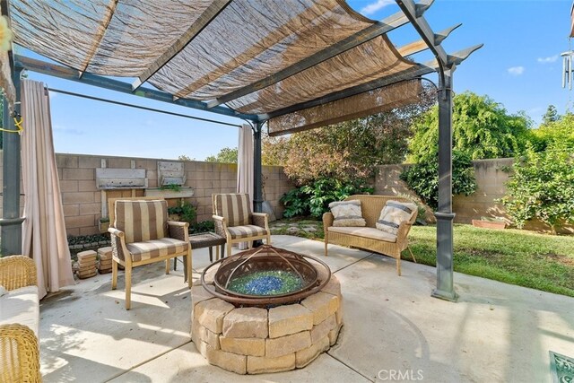 view of patio with a pergola and a fire pit