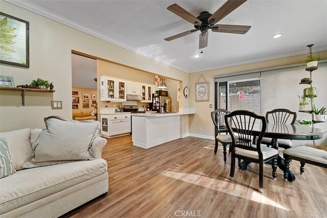 living room featuring crown molding, ceiling fan, and light wood-type flooring