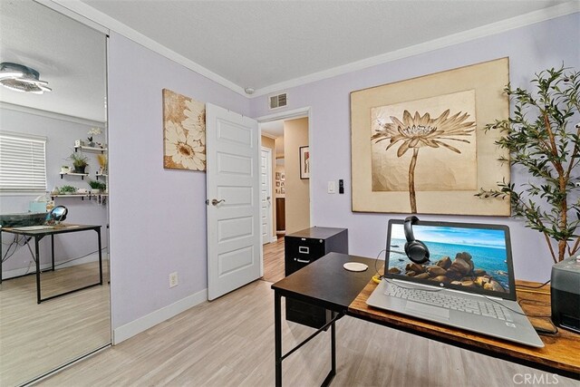 office area featuring ornamental molding, a textured ceiling, and light hardwood / wood-style flooring