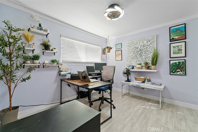 office space with ornamental molding, a textured ceiling, and light wood-type flooring