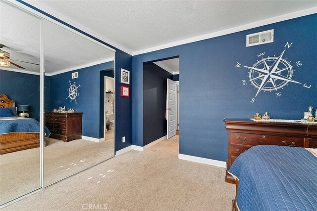 bedroom with ceiling fan, crown molding, a textured ceiling, a closet, and carpet