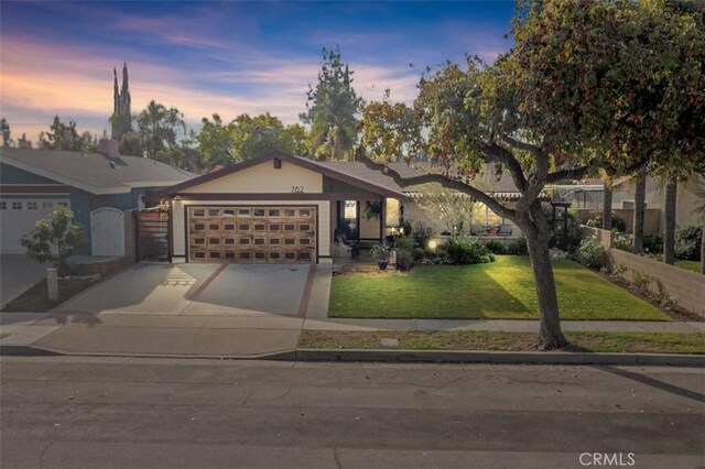 ranch-style home with a lawn and a garage