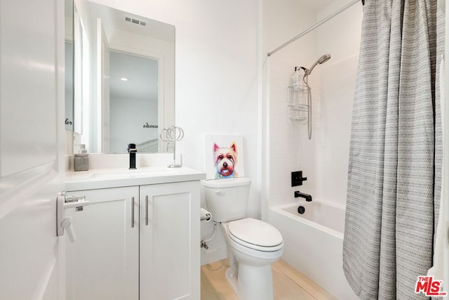 full bathroom featuring toilet, shower / bath combo, vanity, and tile patterned floors