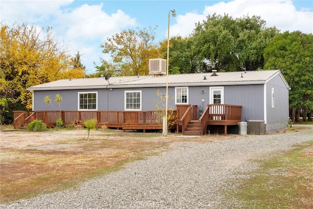 back of house featuring cooling unit and a deck